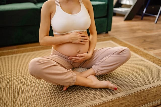 Pregnant woman sat on floor