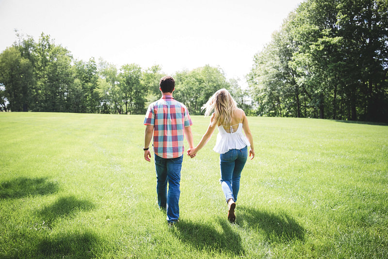 Man & woman holding hands in a park